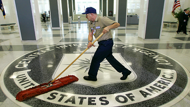 A workman quickly slides a dustmop over the floor at the Central Intelligence Agency headquarters in Langley, Va., near Washington, Thursday, March 3, 2005. (AP Photo/J. Scott Applewhite)