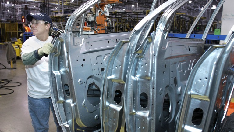 LANSING, MI - MARCH 10: General Motors employees assemble a GM crossover SUV on the assembly line at the GM Lansing Delta Township Assembly Plant March 10, 2010, in Lansing, Michigan. The Delta plant has more than 3,000 workers on two shifts and is expected to add a third shift of 900-1,000 workers in April. The plant produces the Buick Enclave, Chevrolet Traverse, and GMC Acadia crossover SUVs. (Photo by Bill Pugliano/Getty Images)