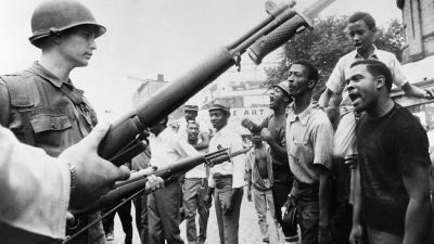 Black demonstrators face armed federal soldiers in Newark on July 17, 1967 during riots that erupted in the town following a police operation. (Photo by AFP/Getty Images)