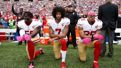 Eli Harold (#58), Colin Kaepernick (#7) and Eric Reid (#35) of the San Francisco 49ers kneel in protest on the sidelines during the national anthem prior to the game against the Buffalo Bills at New Era Field on Oct. 16, 2016. (Photo by Michael Zagaris/San Francisco 49ers/Getty Images)